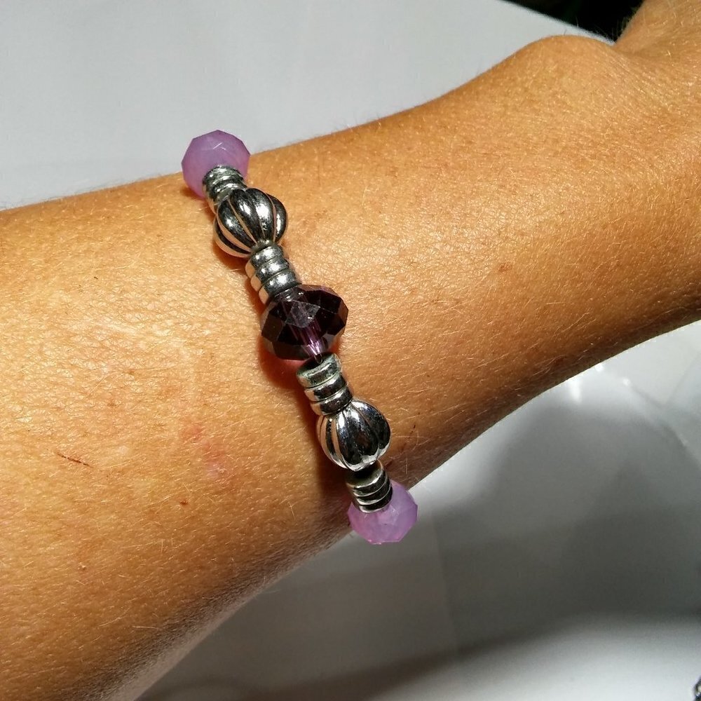 Women`s silver tone purple beads on wire bracelet.